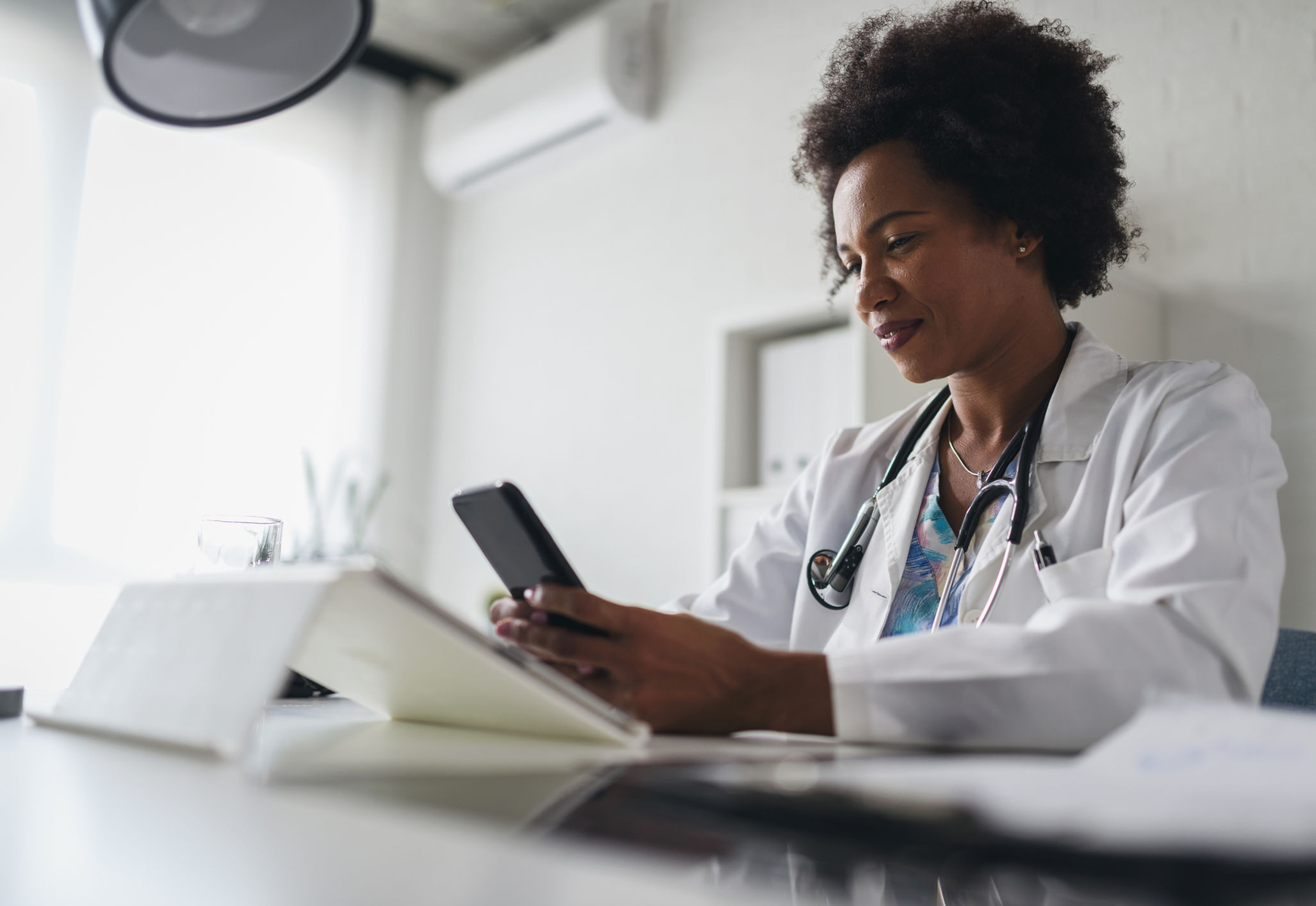 Healthcare professional using telehealth tools in a clinical setting.